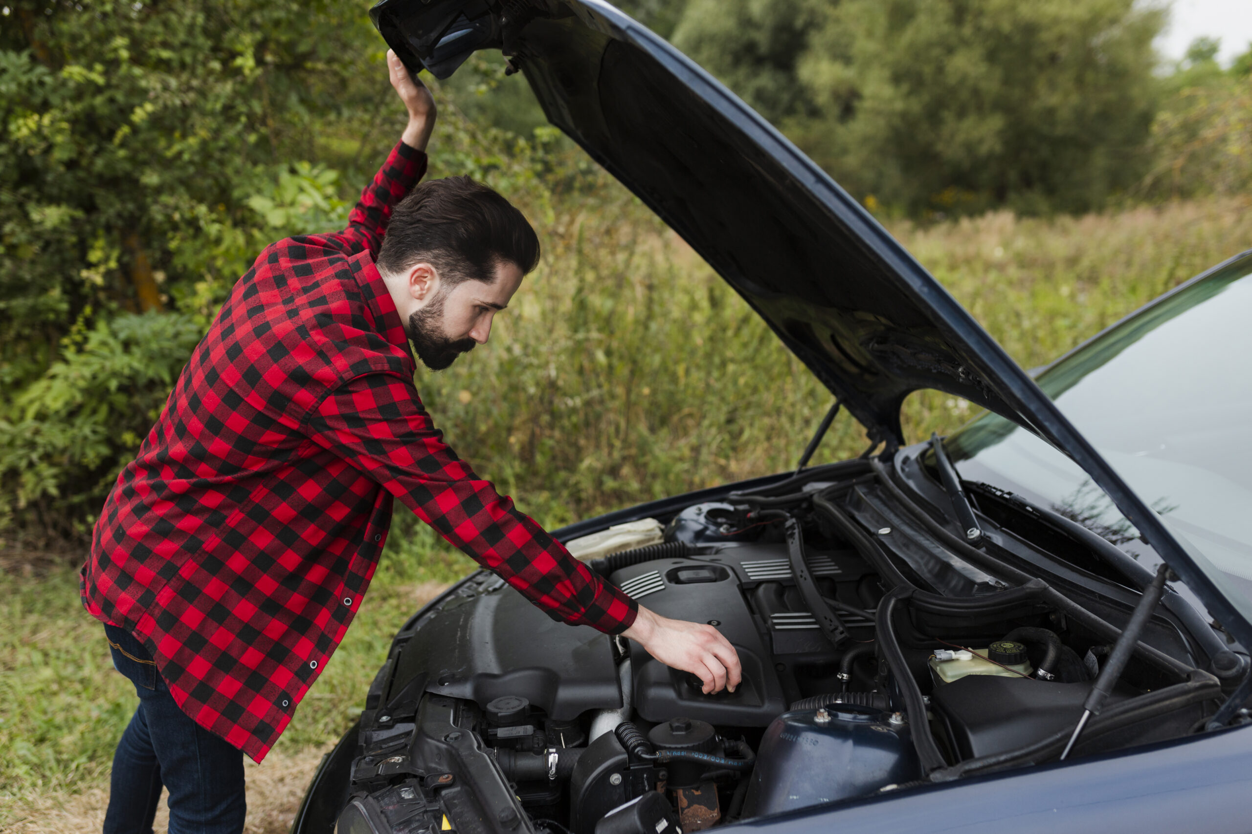 side-view-man-checking-engine